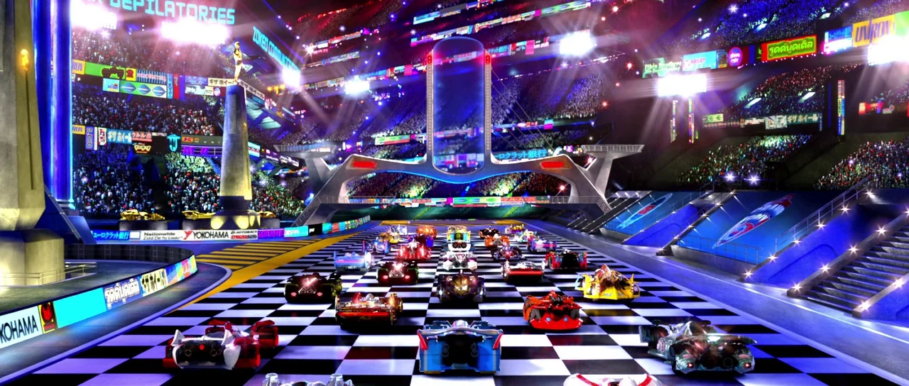 Speed Racer (2008) movie still: wide — A massive futuristic racing stadium features a checkered track and tiered spectator stands. Dozens of…
