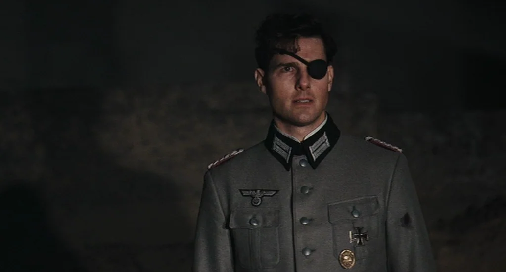 Valkyrie (2008) movie still: medium — A dark, rocky desert landscape at night provides the backdrop for a military figure. A man in a German officer…