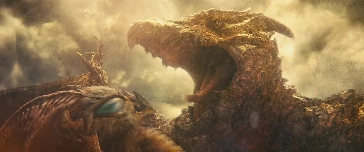Godzilla: King of the Monsters (2019) movie still: medium — Two giant monsters encounter each other while flying through dense, storm-lit clouds.…
