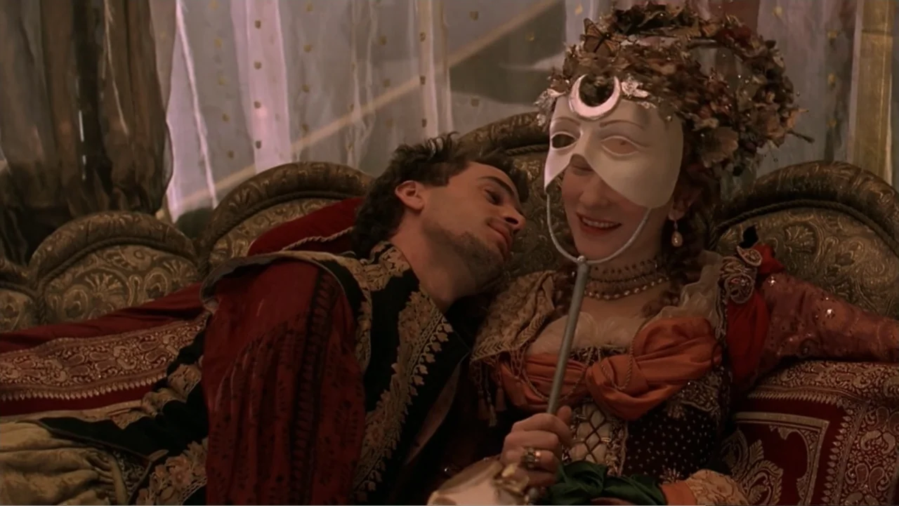 Elizabeth (1998) movie still: medium — An ornate interior features a plush sofa with elaborate gold-trimmed upholstery and velvet textiles. A man…
