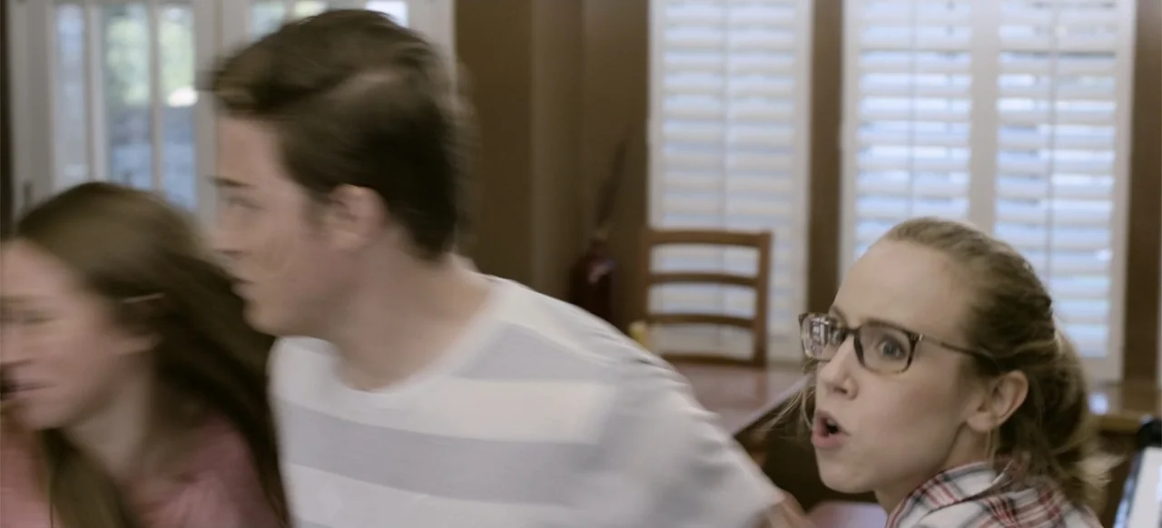 Hellbreeder (2004) movie still: medium — A domestic dining area with white plantation shutters on the windows in the background. Three young adults…