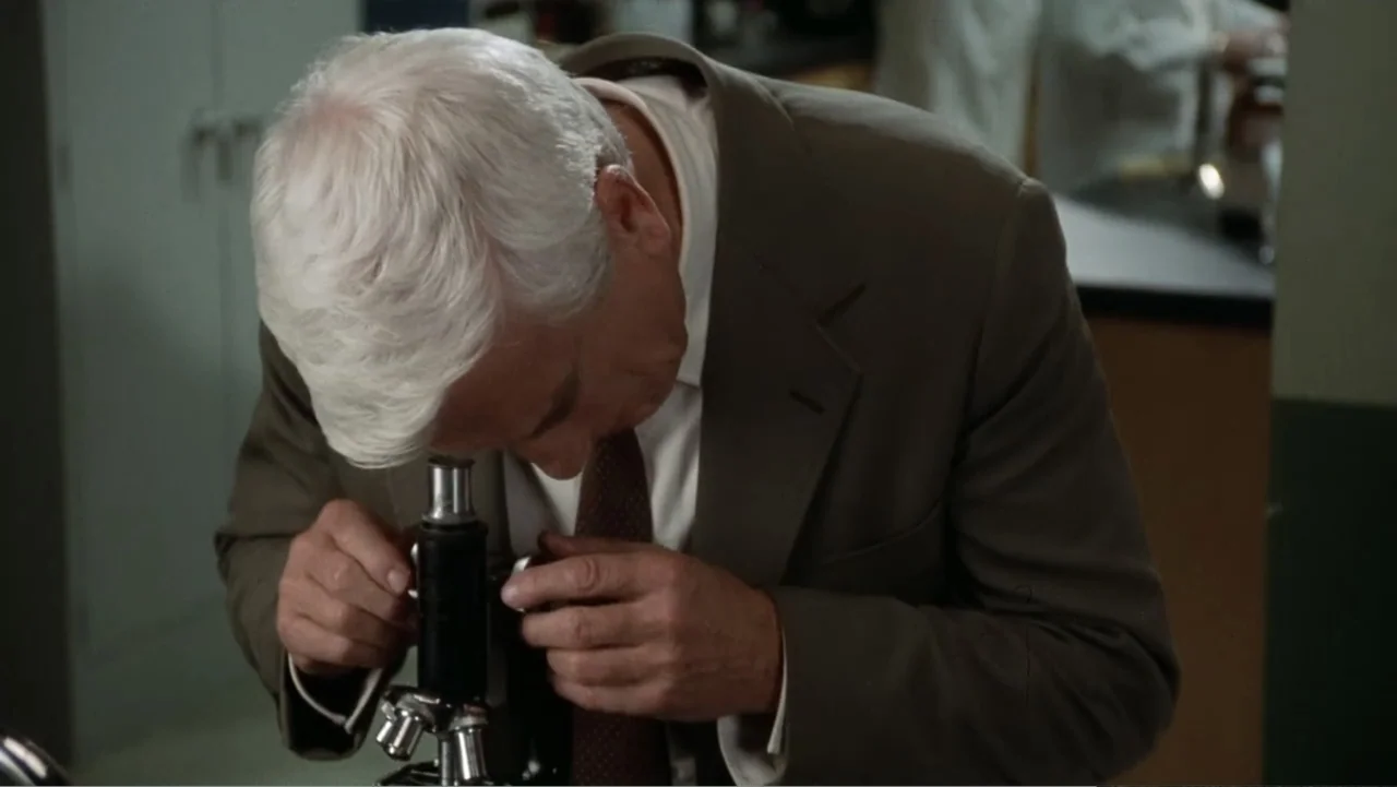 The Naked Gun: From the Files of Police Squad! (1988) movie still: medium — A laboratory setting contains scientific equipment and lab surfaces…