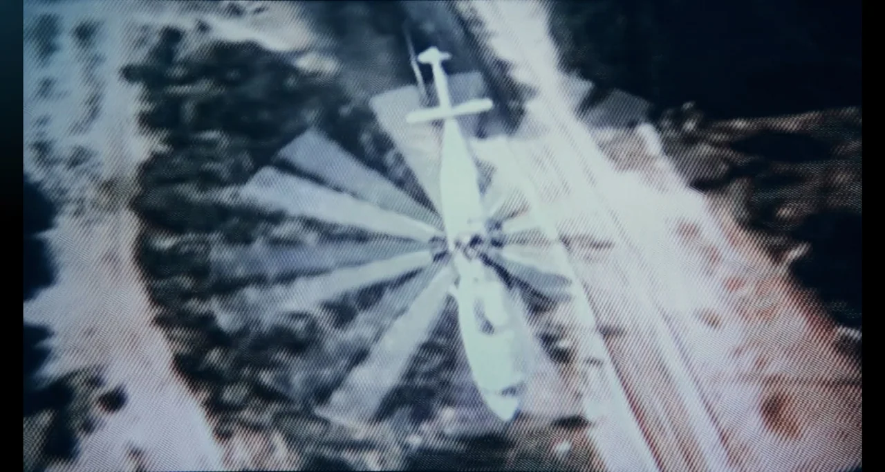 Chernobyl's Café (2016) movie still: establishing — An aerial view shows a field with scrub vegetation and a dirt path. A helicopter hovers directly…