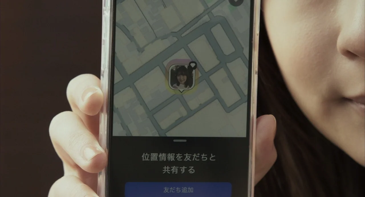 Stigmatized Properties: Possession (2025) movie still: closeup — An interior space features a close-up of a smartphone held in a hand. The screen…