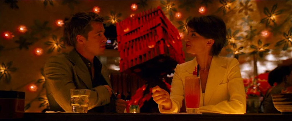 Ocean’s Thirteen (2007) movie still: medium — A dimly lit dining area features floral wall decorations with glowing miniature lights throughout. A…