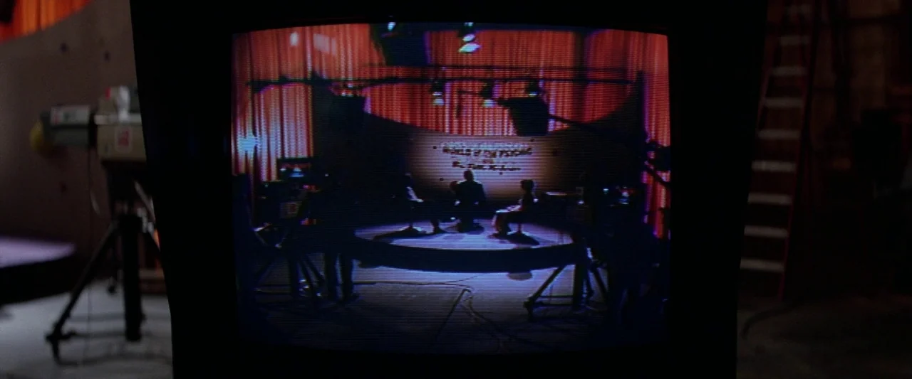 Ghostbusters 2 (1989) movie still: wide — A vintage television monitor displays a talk show broadcast from a studio set. Three silhouettes of people…