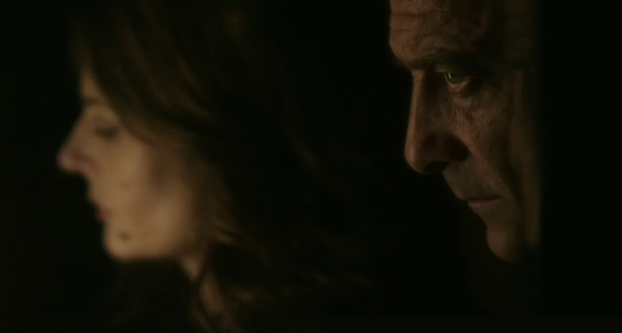 Bastards (2013) movie still: medium — A dark space obscures all background detail and defines the subjects by subtle light. The man in the…