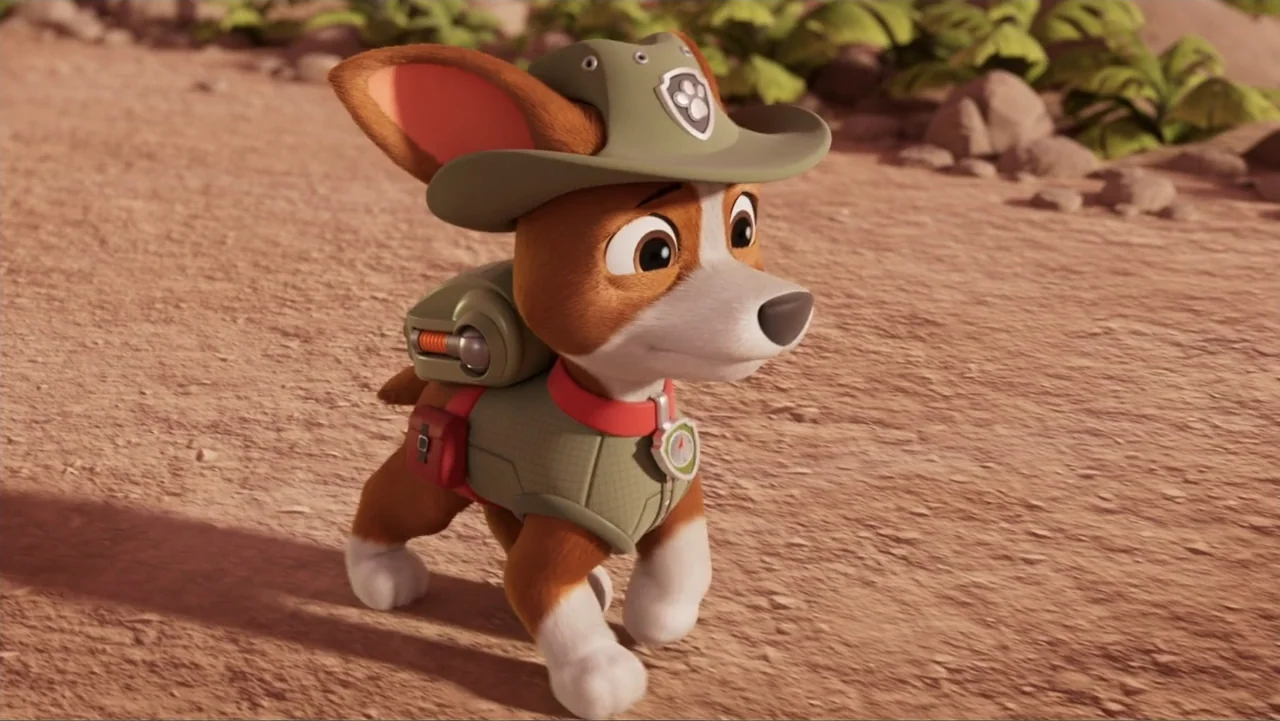 Valiente: A Tracker Story (2025) movie still: medium — A brown and white puppy walks along a dry dirt trail with sparse green vegetation. The small…