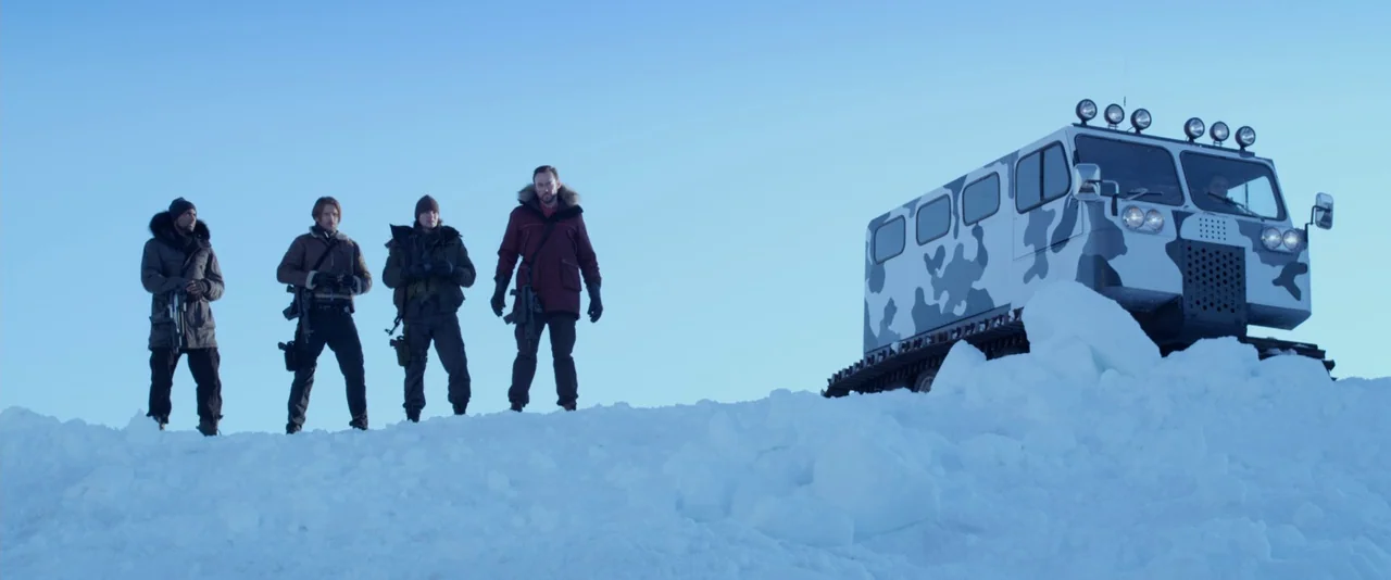 Resident Evil: Retribution (2012) movie still: fullbody — Four armed individuals stand on a large, uneven ridge of packed white snow. To their…