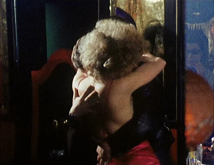 Rio Das Mortes (1971) movie still: closeup — A dark, dimly lit environment with reflective surfaces and indistinct decorative background elements.…