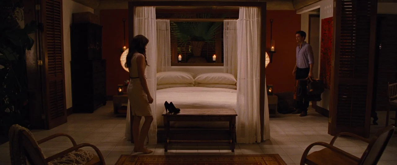 The Twilight Saga: Breaking Dawn – Part 1 (2011) movie still: wide — A spacious resort hotel room features a large four-poster bed with white fabric…