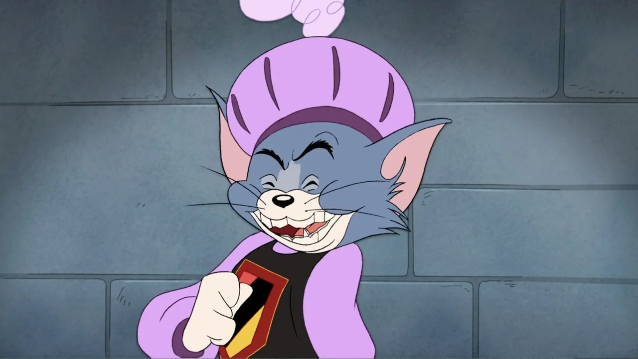 Tom and Jerry: Robin Hood and His Merry Mouse (2012) movie still: medium — An interior space with a grey brick wall in the background. An animated…