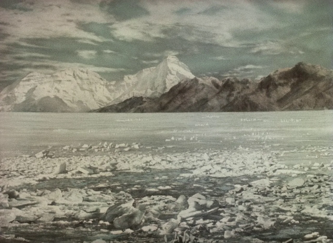 A Journey to the Beginning of Time (1955) movie still: establishing — A vast, frozen coastal landscape features jagged ice floes scattered across…