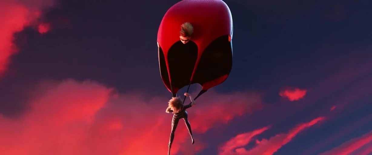 Incredibles 2 (2018) movie still: wide — A figure hangs from a large, bright red parachute against a vibrant sunset sky. Dark clouds drift behind…