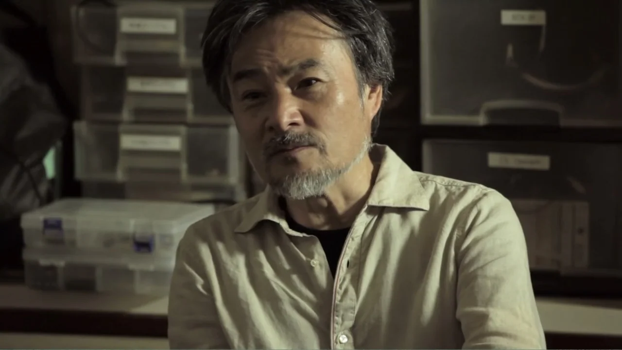Flowers of Taipei: Taiwan New Cinema (2014) movie still: medium — A cluttered storage room filled with plastic storage bins is behind the subject. A…
