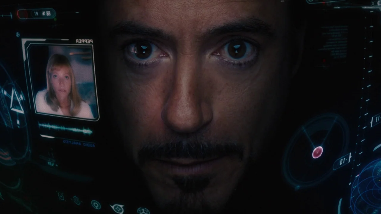 The Avengers (2012) movie still: closeup — Inside a high-tech helmet with a translucent digital interface layered over the user's view. A man stares…