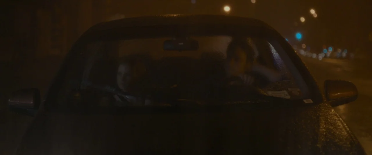 The Disappearance of Eleanor Rigby: Her (2014) movie still: medium — A car windshield is covered in raindrops during a dark night. Two people are…