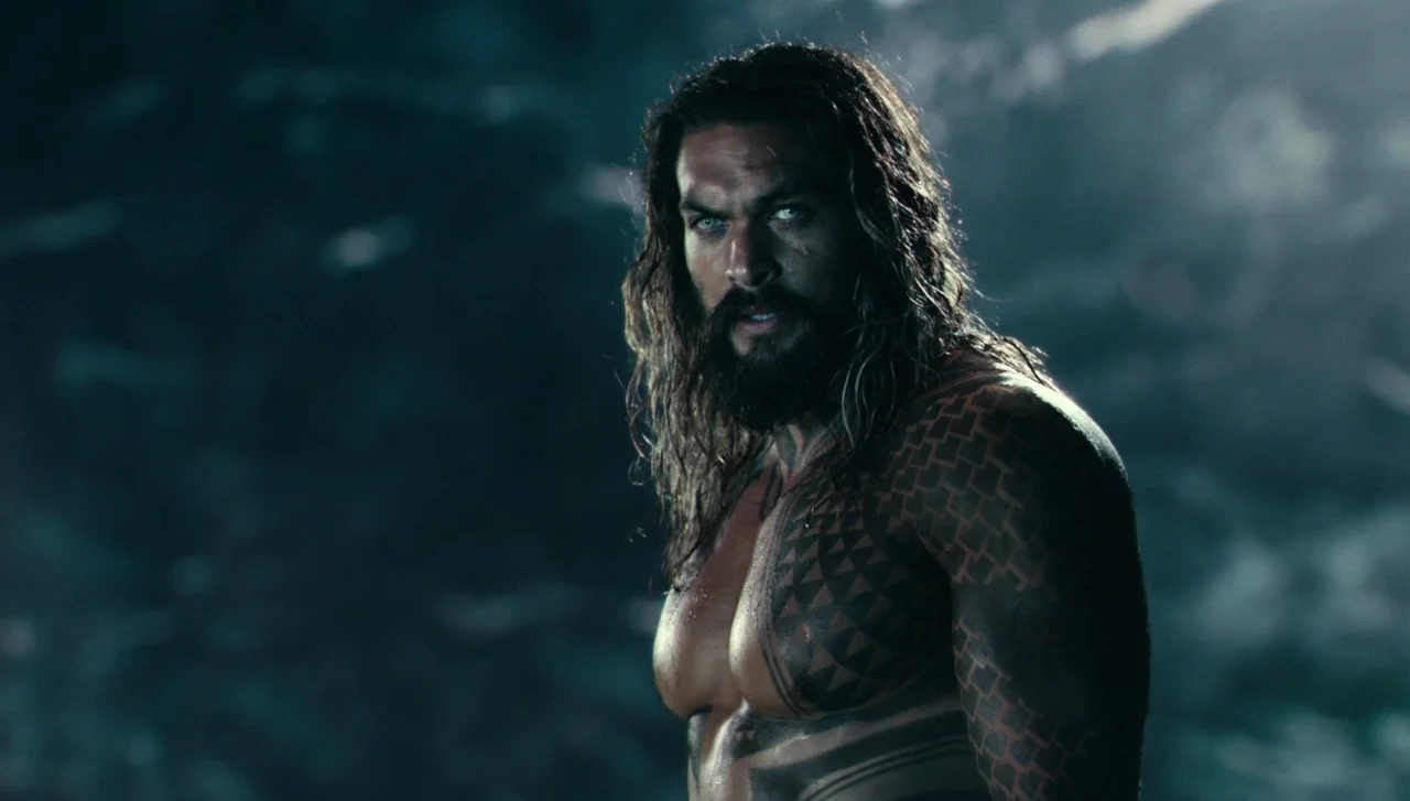 Justice League (2017) movie still: medium — A dark, murky environment filled with floating particulate matter resembles an underwater setting. A…