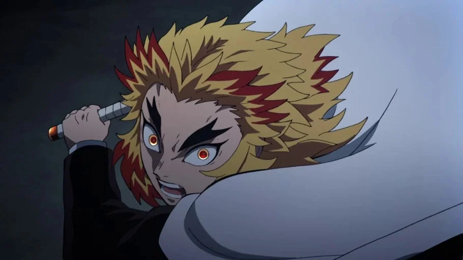 Demon Slayer: Kimetsu no Yaiba (2019) movie still: closeup — A character with flame-patterned hair is captured in a close-up against a dark…