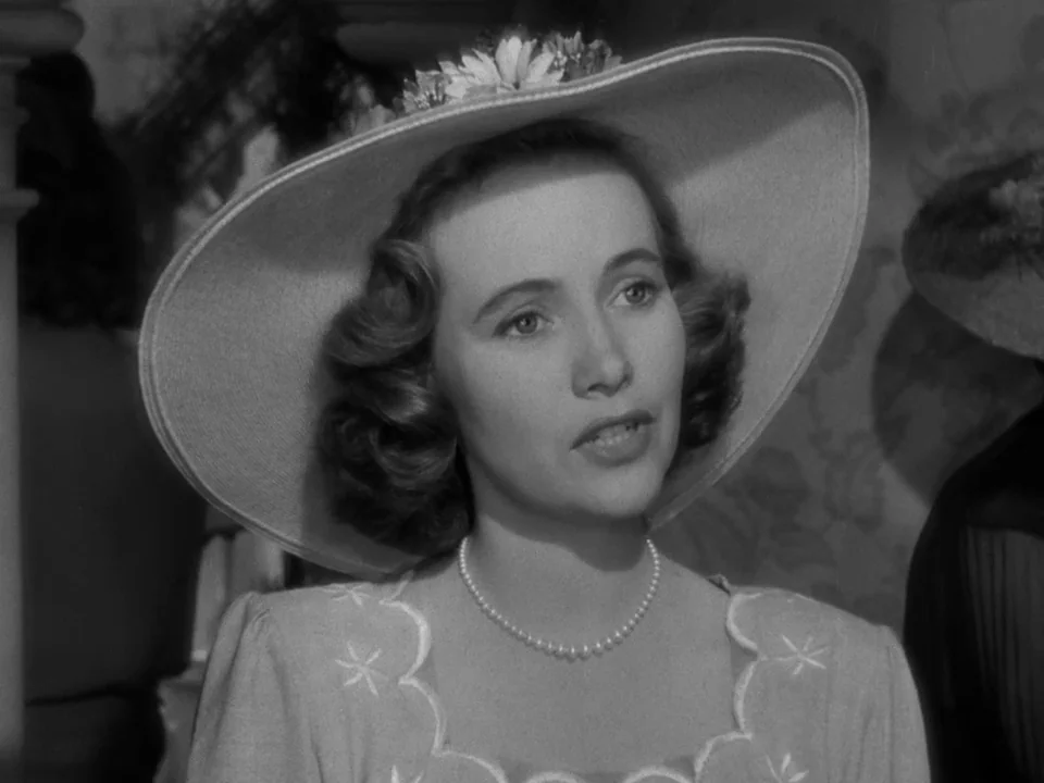 The Best Years of Our Lives (1946) movie still: closeup — A well-lit indoor space featuring light floral wallpaper and architectural accents. A…
