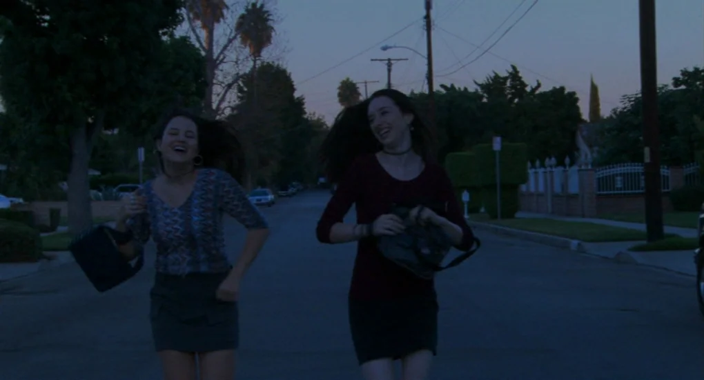 Me and You and Everyone We Know (2005) movie still: fullbody — A quiet suburban street with utility poles and residential houses during early…