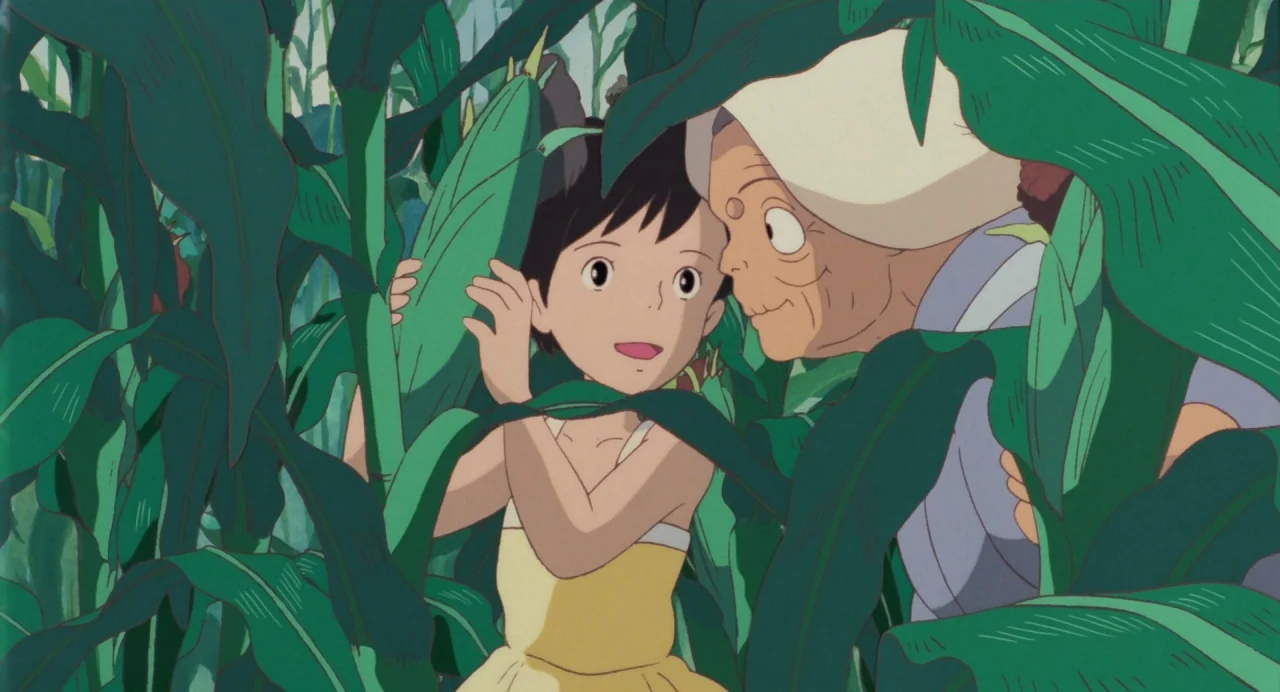 My Neighbour Totoro (1988) movie still: medium — A dense cornfield features tall stalks with wide green leaves obscuring most visibility. A young…