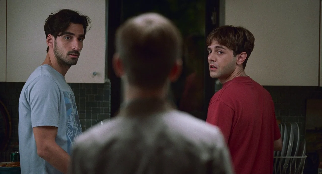 Matthias & Maxime (2019) movie still: medium — A residential kitchen features dark tiled backsplashes and light-colored cabinetry. Two men stand…