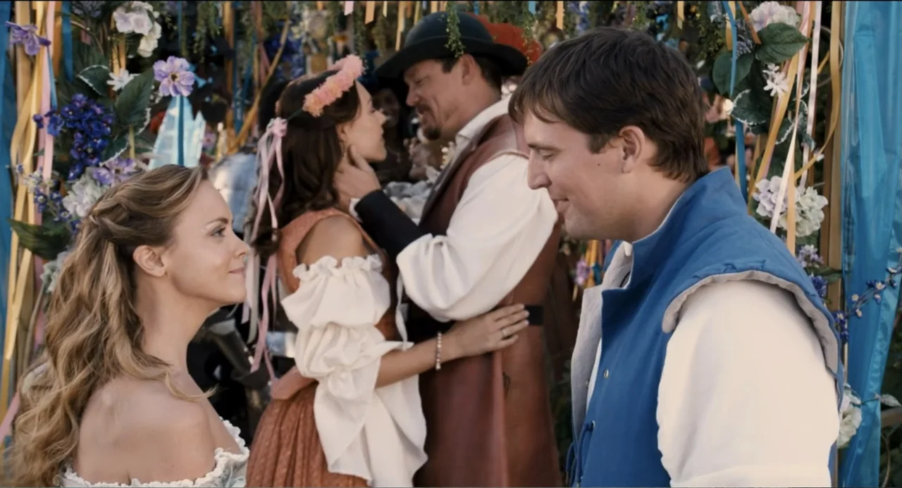 Todo es amor (2024) movie still: medium — A festive outdoor area decorated with colorful ribbons and hanging silk flowers. Three people stand near…