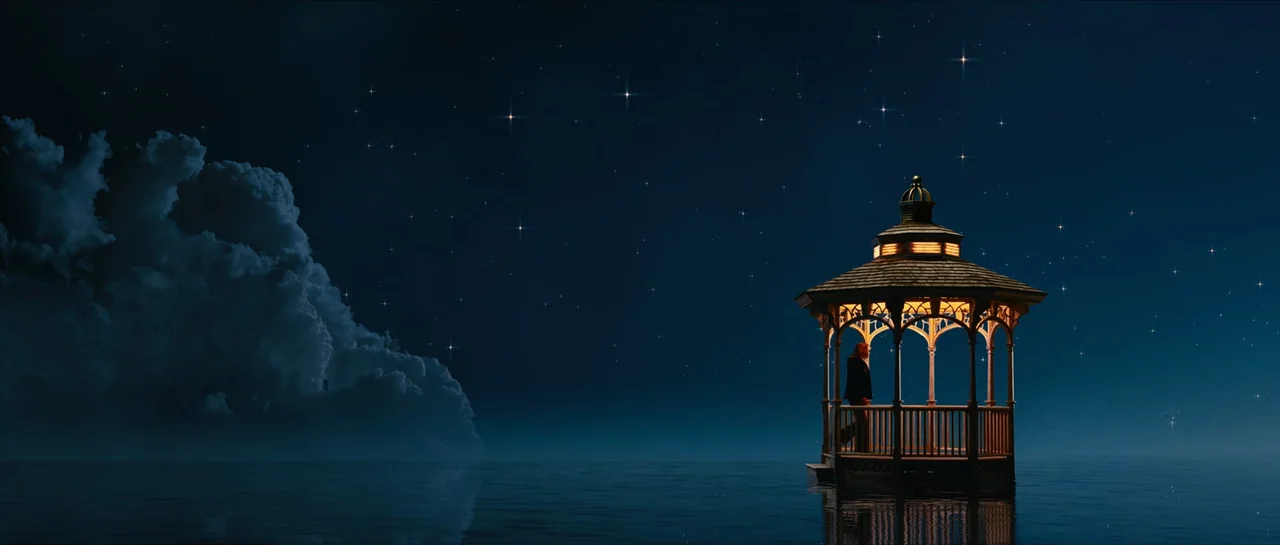 The Lovely Bones (2009) movie still: wide — A wooden gazebo sits on calm dark water under a starry night sky. A woman stands alone inside the…