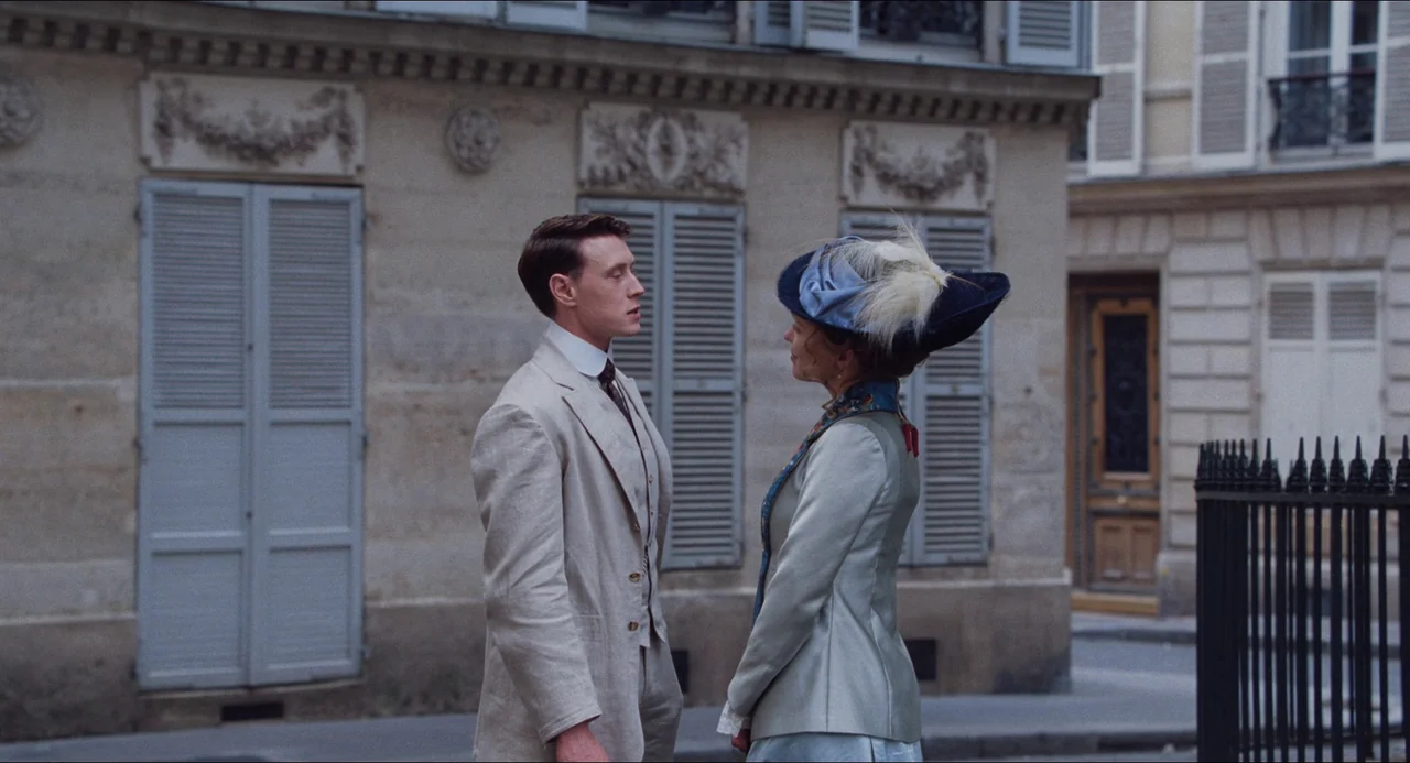 Transformers: Rise of the Beasts (2023) movie still: fullbody — A Parisian street features a light-colored limestone building with shuttered windows…