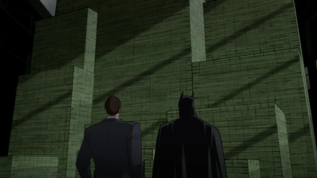 Batman: The Long Halloween, Part One (2021) movie still: medium — A high, textured green wall rises above a street-level area. A man in a suit and a…
