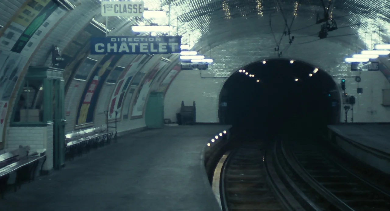 Le Samouraï (1967) movie still: establishing — A Parisian underground subway station features arched white tiled walls and hanging signage. The…
