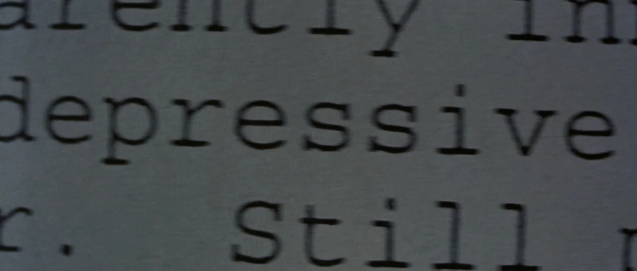 Don't Say a Word (2001) movie still: closeup — A close-up view of a typewritten document on white paper. The text contains the words depressive and…