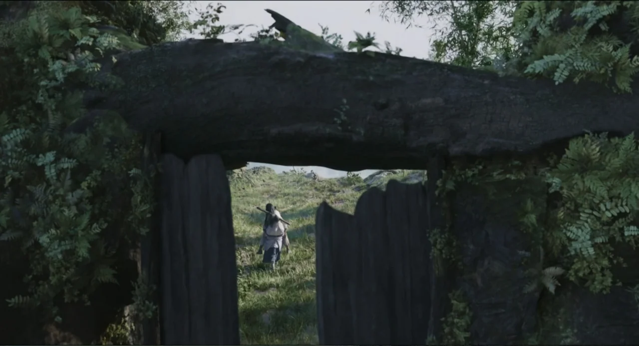 Legends of the Condor Heroes: The Gallants (2025) movie still: wide — A dark wooden gate frame covered in ferns opens onto an expansive open field.…