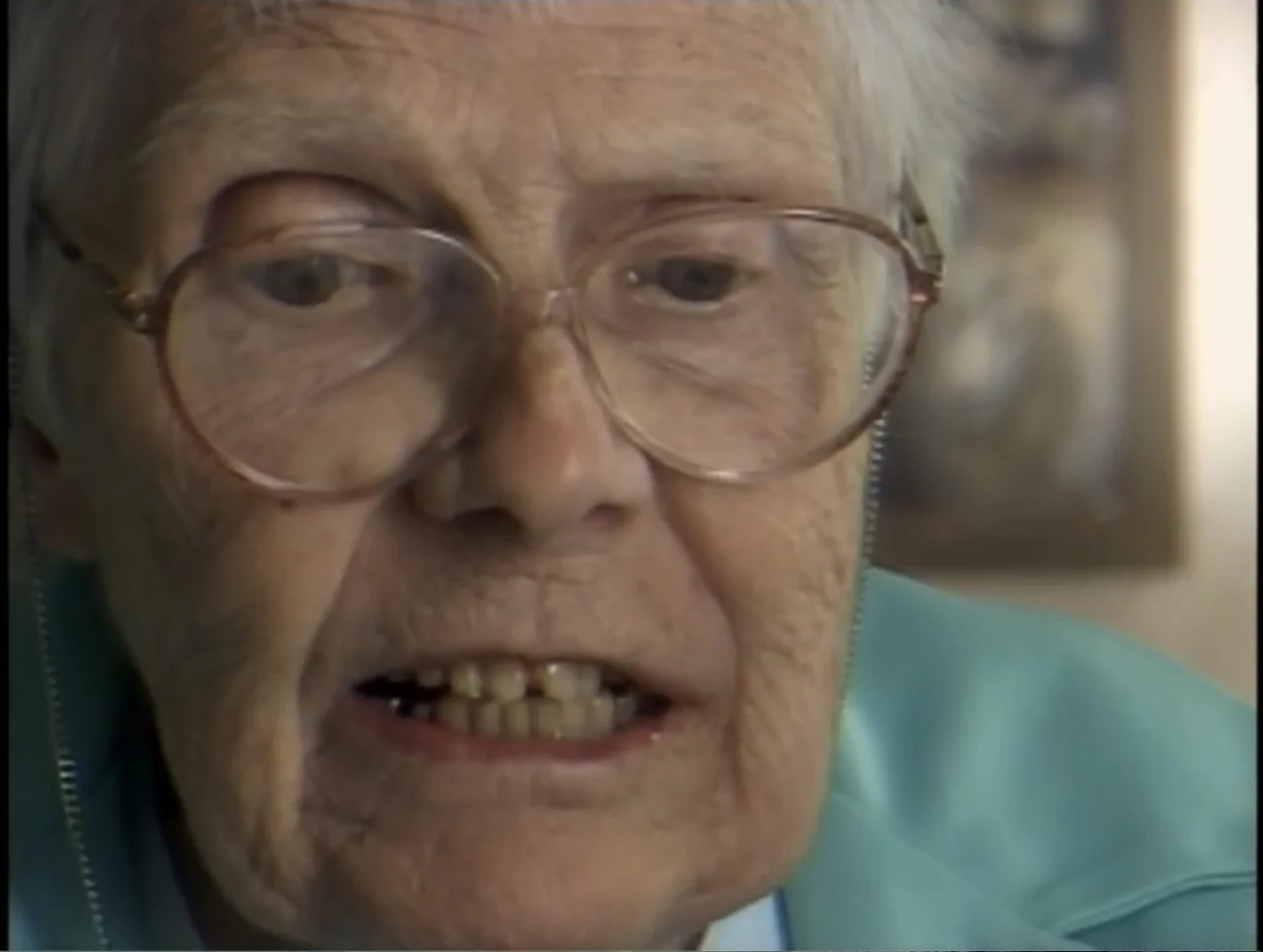 A Rape in a Small Town: The Florence Holway Story (2005) movie still: closeup — An indoor living space with blurred artwork visible on the…