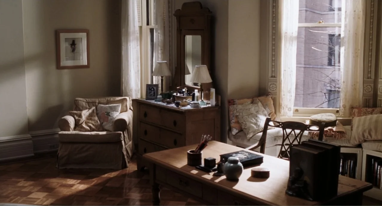 You've Got Mail (1998) movie still: establishing — A quiet study features wooden furniture including a desk, a dresser, and an armchair. Sunlight…
