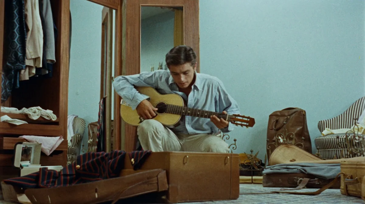 Purple Noon (Plein Soleil) (1960) movie still: medium — A hotel room with light blue walls, a wooden wardrobe, and open travel luggage. A young man…