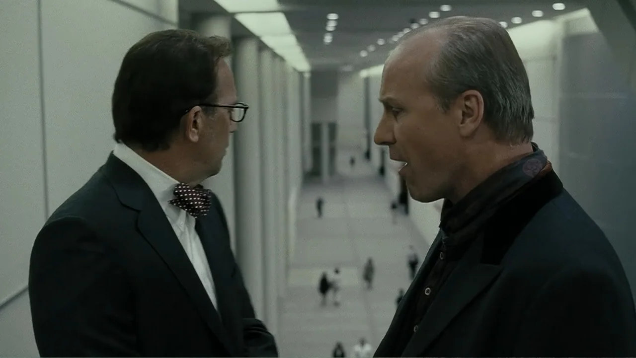 Mr. Brooks (2007) movie still: medium — A minimalist, high-ceilinged modern atrium features concrete pillars and expansive white walls. Two men…