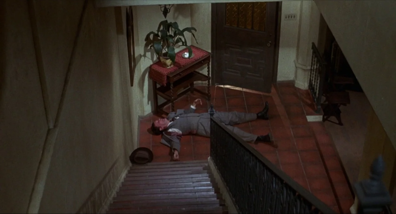 What’s the Matter with Helen? (1971) movie still: wide — A terracotta-tiled entryway floor features a wooden console table with a potted plant. A…