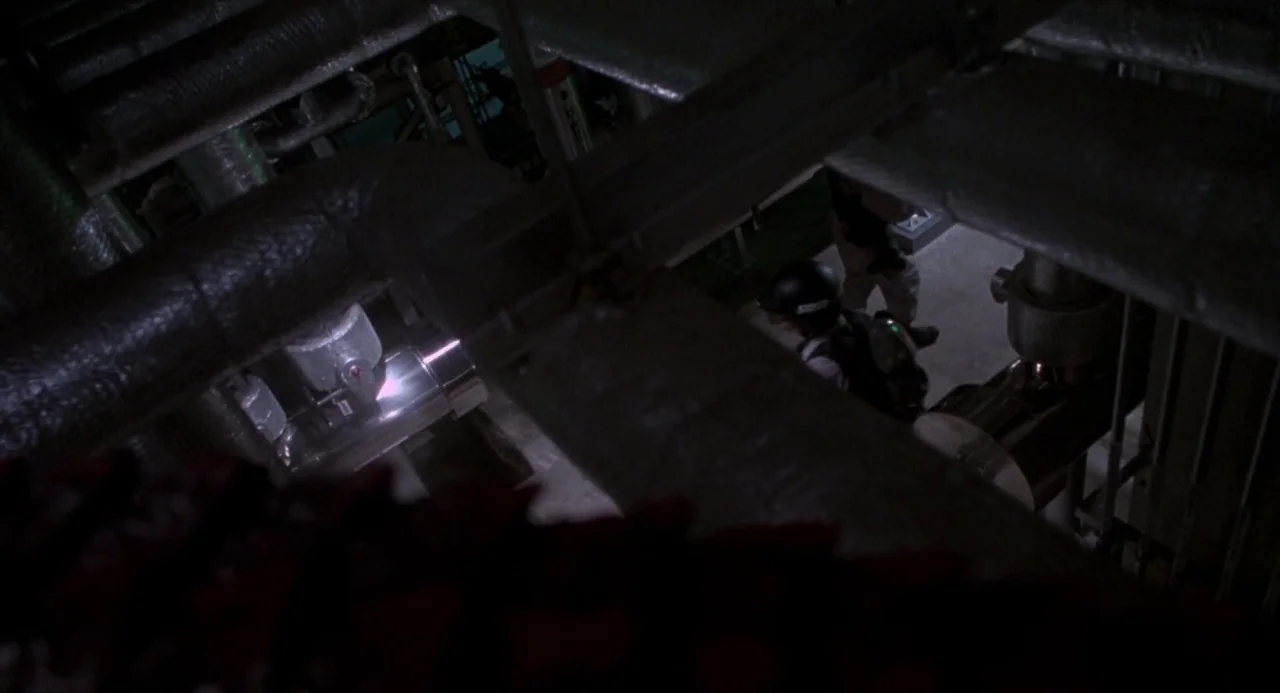 Godzilla vs. Destoroyah (1995) movie still: wide — An industrial facility basement is filled with complex overhead piping and metallic…
