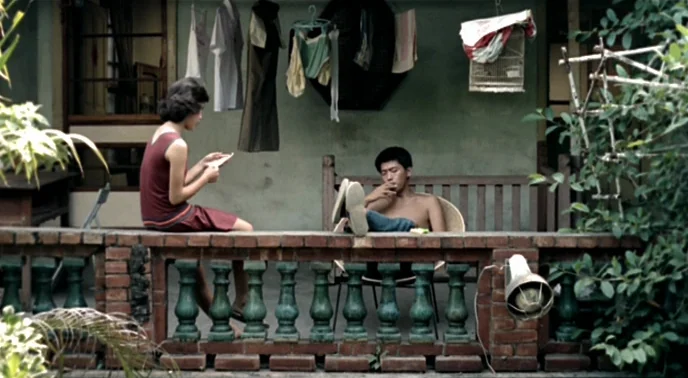 The Boys From Fengkuei (1983) movie still: wide — A residential veranda features a brick railing with green balusters and laundry hanging above. A…