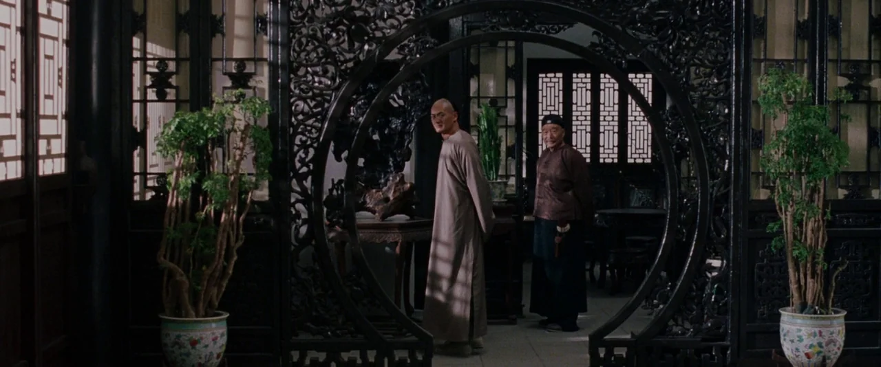 Crouching Tiger, Hidden Dragon (2000) movie still: wide — A traditional wooden interior features an elaborate carved circular partition separating…