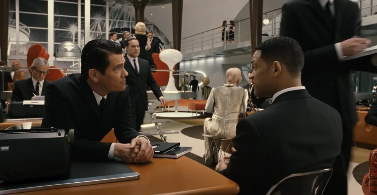 Men in Black 3 (2012) movie still: medium — A retro-futuristic workspace features mid-century modern furniture and large glass windows overlooking a…