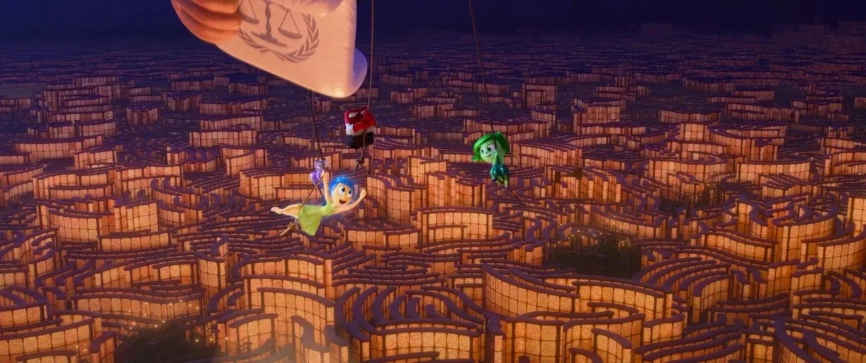 Inside Out 2 (2024) movie still: wide — A massive interconnected maze glows with warm amber light against a dark background. Several small animated…