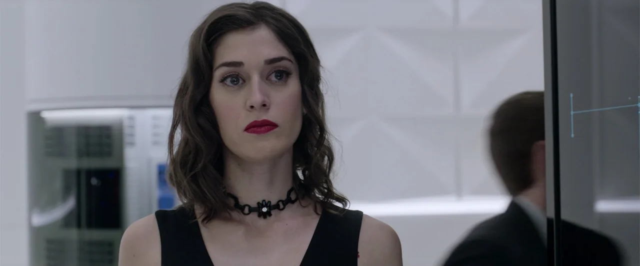 Now You See Me 2 (2016) movie still: medium — A modern sterile white office space features clean wall panels and a glass interface. A woman in a…