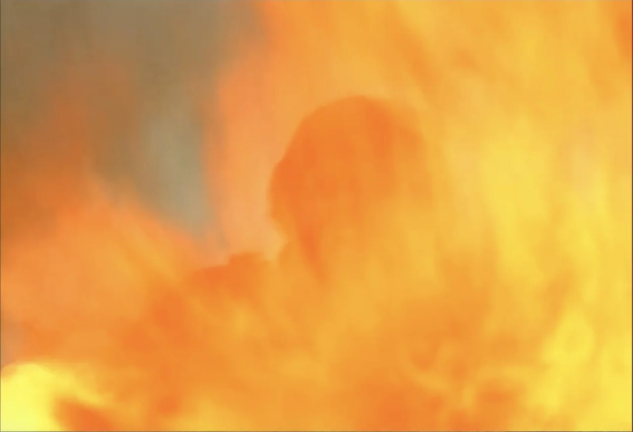 When Trumpets Fade (1998) movie still: closeup — A close-up view of intense, bright orange and yellow fire filling the frame. The flames create…