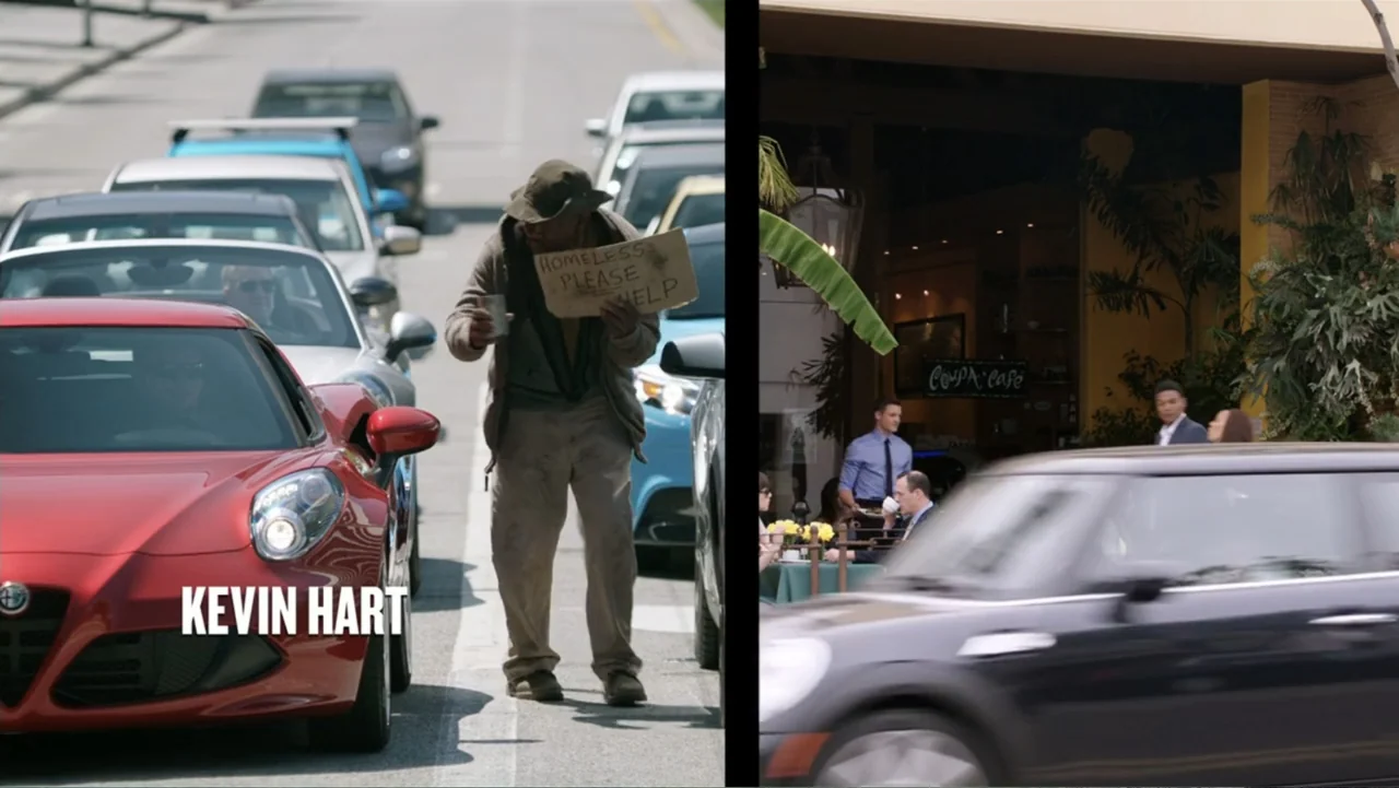 Get Hard (2015) movie still: fullbody — A man stands in the middle of a busy roadway lane between cars. The man holds a cardboard sign with text…
