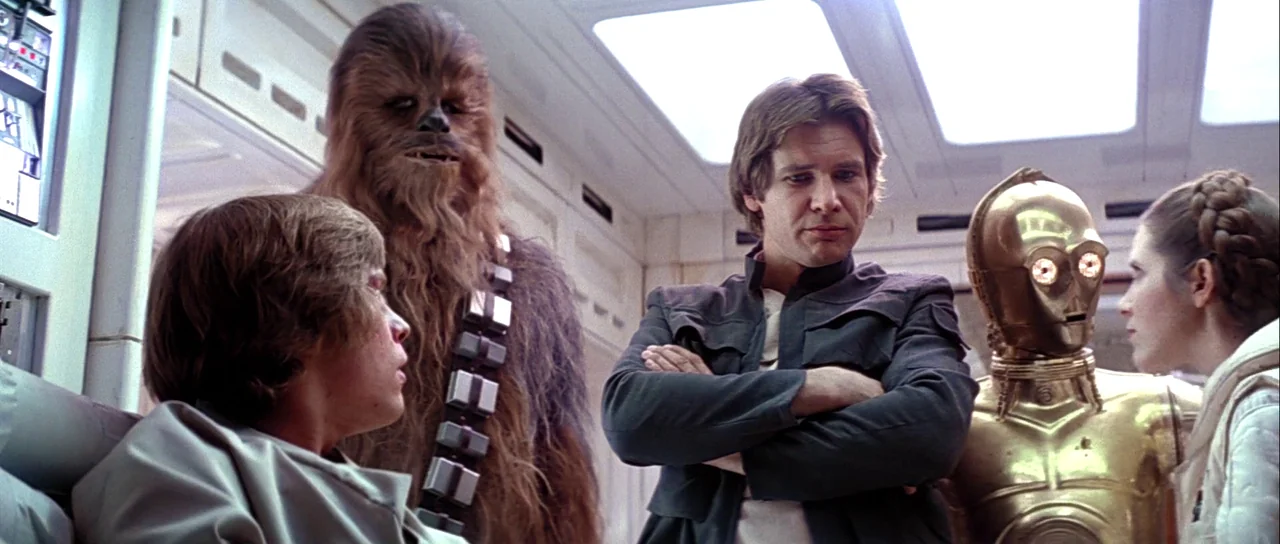 The Empire Strikes Back (1980) movie still: medium — A white-paneled starship interior features soft overhead lighting and clean geometric wall…