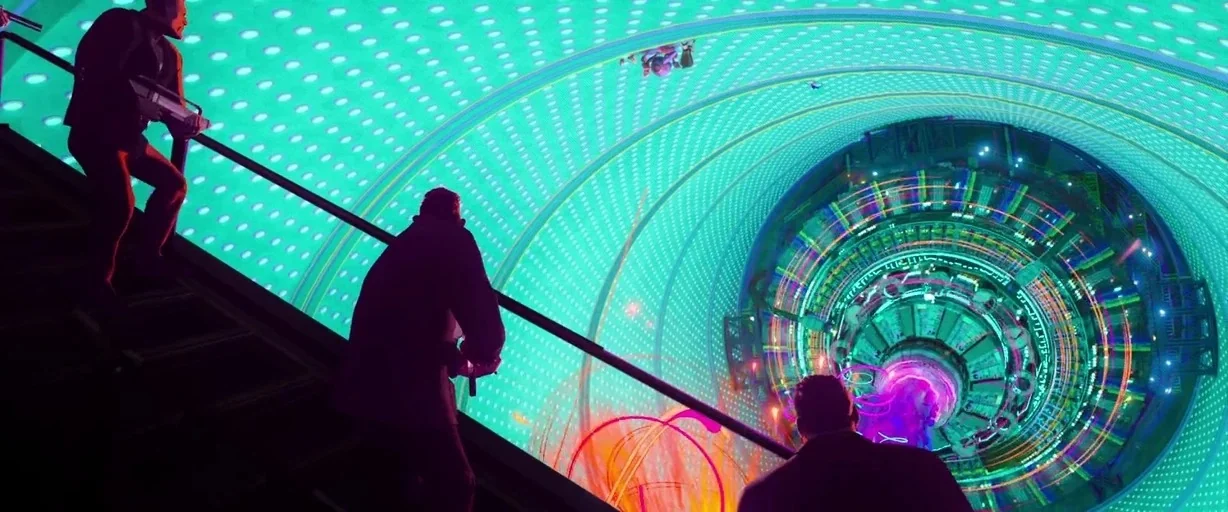Spider-Man: Into the Spider-Verse (2018) movie still: wide — A vast futuristic laboratory features a circular, glowing particle accelerator ring…