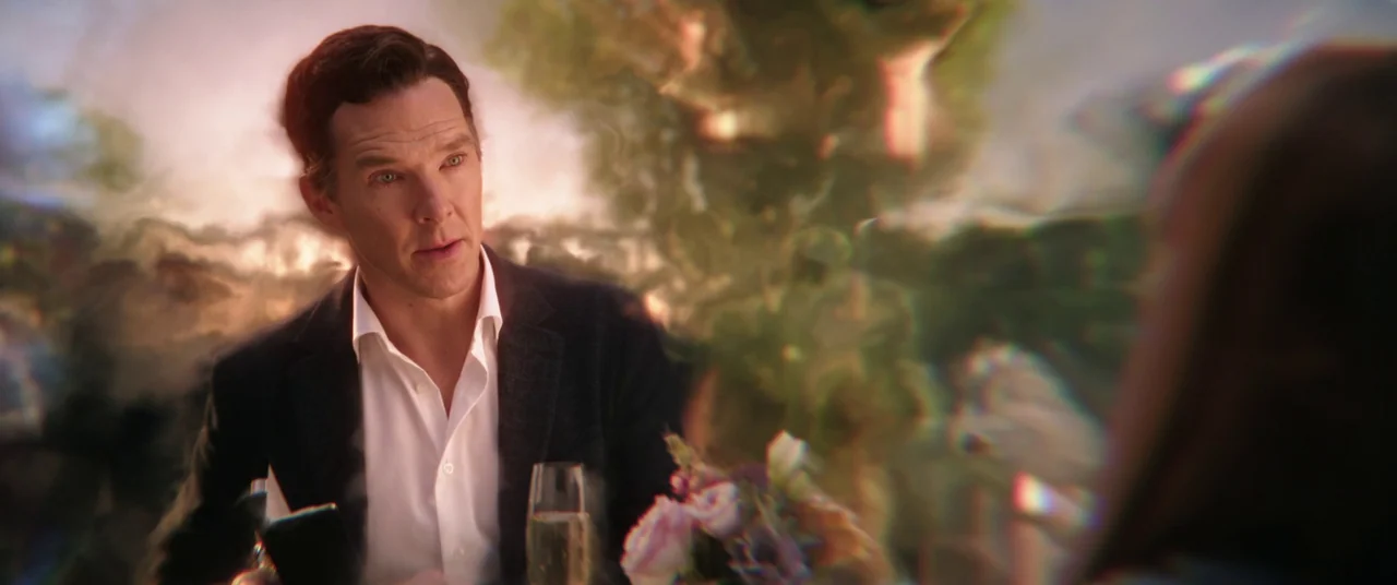 Doctor Strange in the Multiverse of Madness (2022) movie still: medium — An outdoor table setting features a man in a blazer dining at a restaurant.…